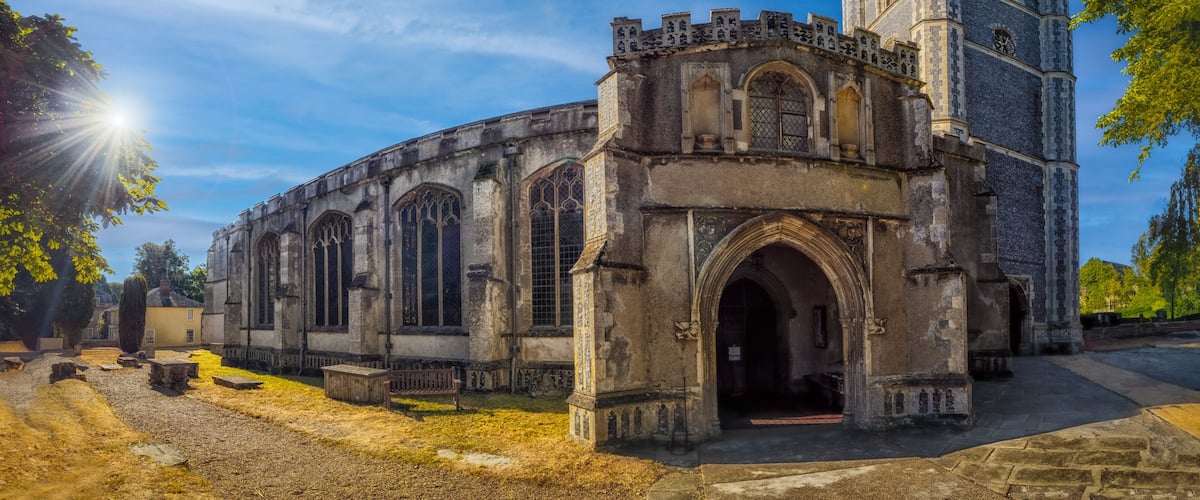 An old church with a prominent tower and arched windows.
