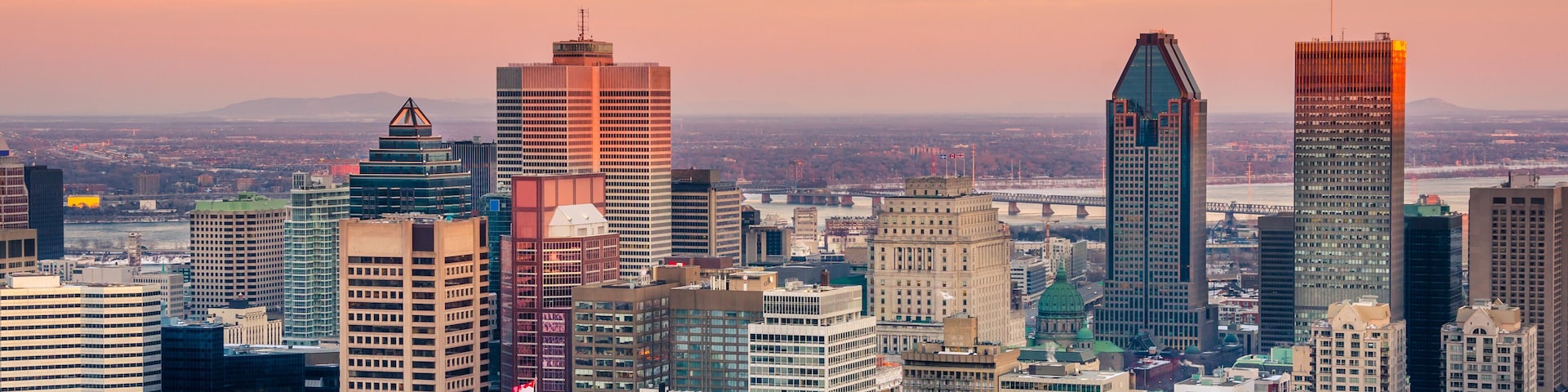 A cityscape with a variety of high-rise buildings, including a distinctive pyramid-shaped skyscraper and a tall building with a pointed top.