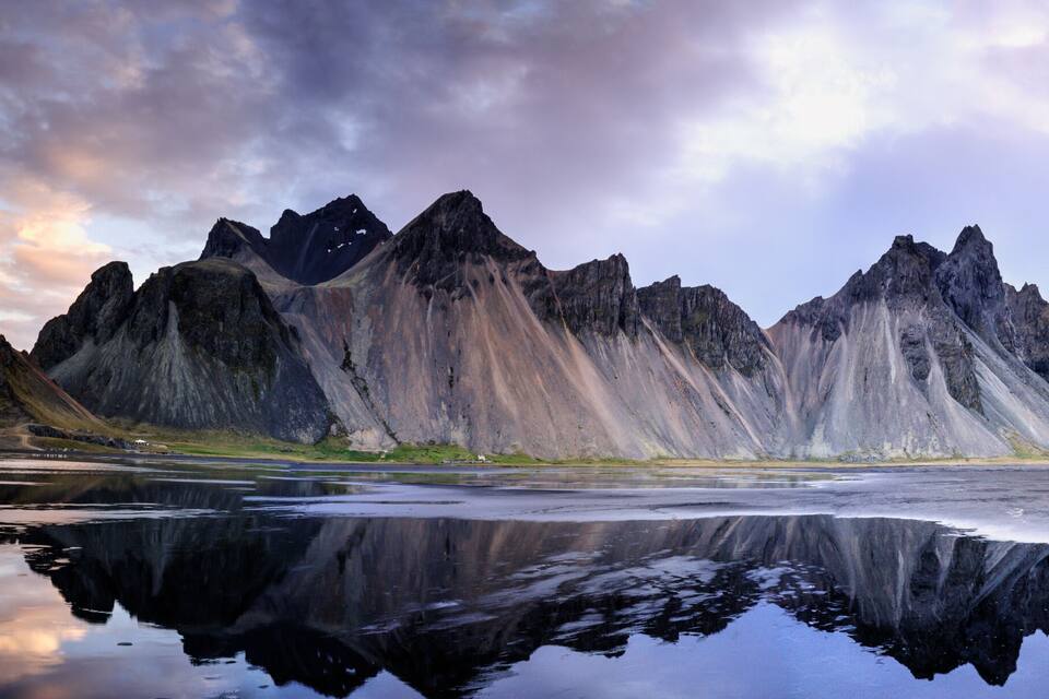 A mountain range with a reflective lake surface.