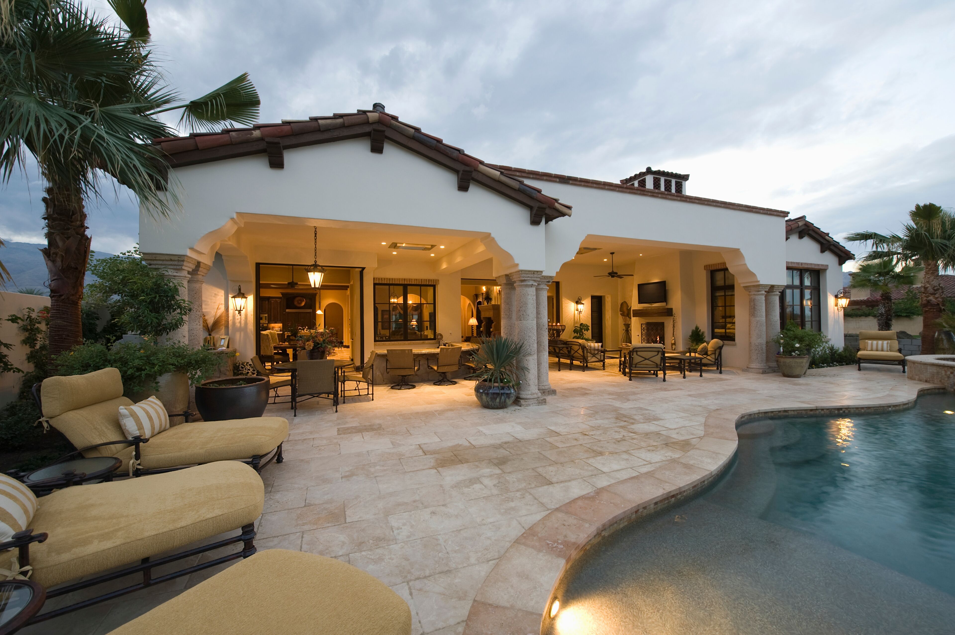 View of sunloungers by the pool against modern home
