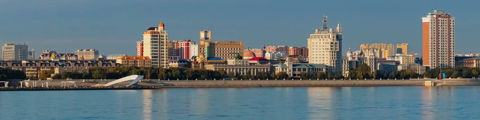 View of the embankment of the city of Heihe, China from the city of Blagoveshchensk, Russia. Border river Amur in the autumn morning.