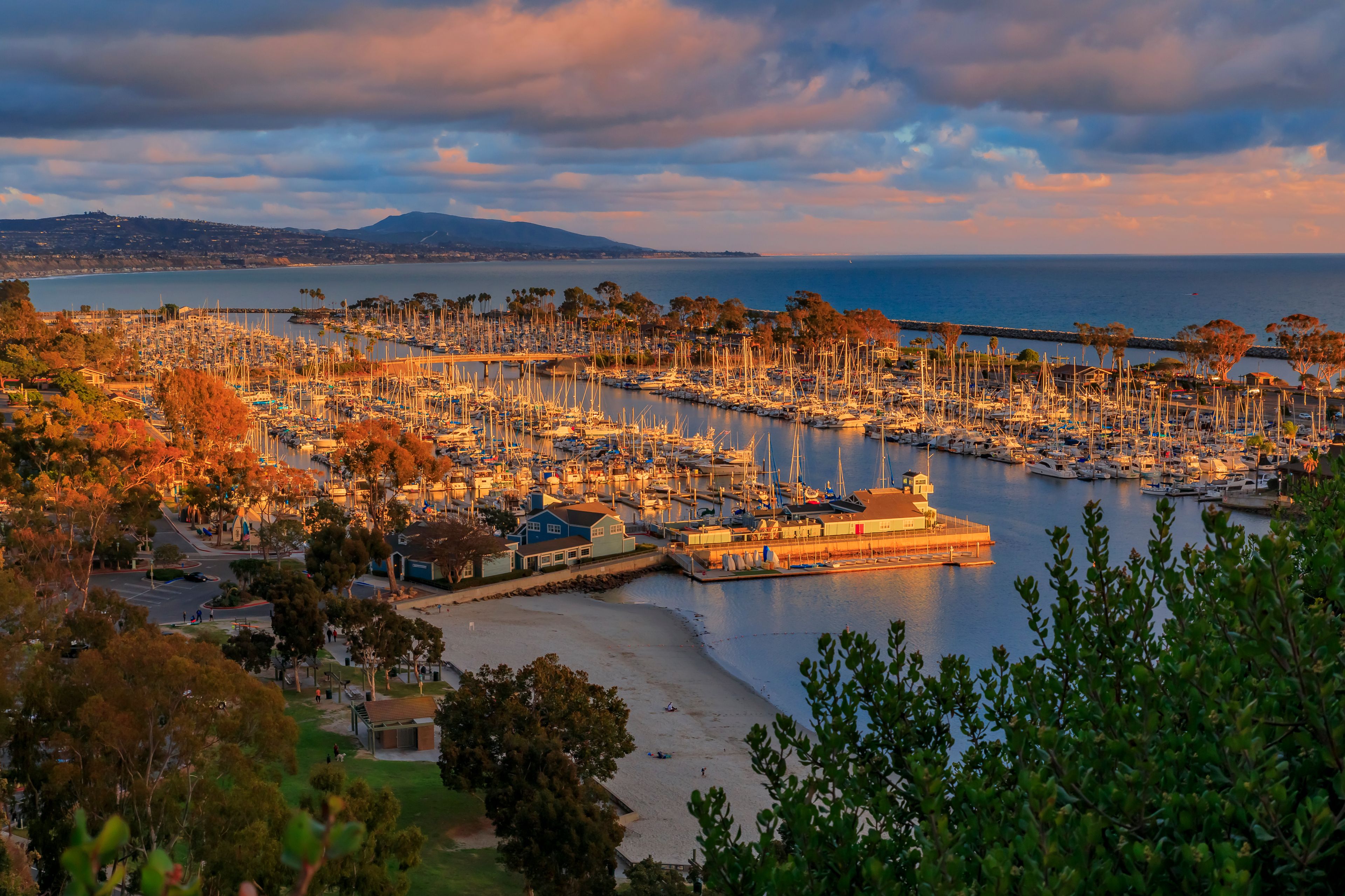 Sunset over luxury yachts and boats in Dana Point harbor, Orange county in Southern California