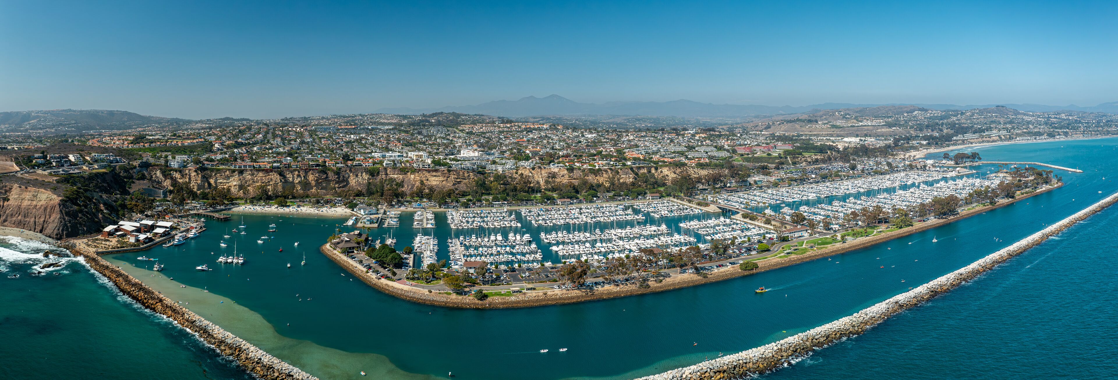 Aerial Panoramic View of Dana Point Harbor and Jetty with Many Boats