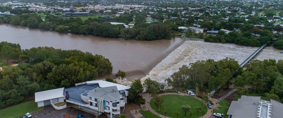 A river flooding a town, a bridge, and a building with a sign 'Riverview Tavern.'