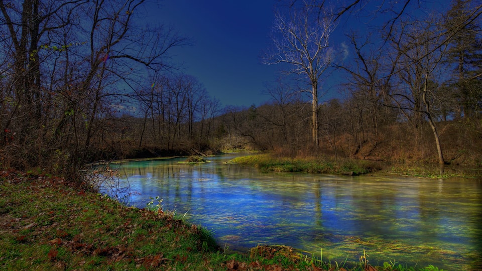 Beautiful blue water flowing from Round Springs emerging from deep in the earths boughs,.