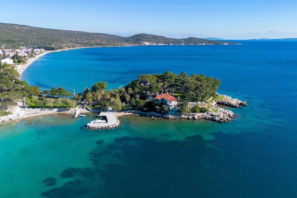 Manal Bay, which is connected to İzmir, is a peaceful and quiet resting area with its deep blue sea in Mordoğan Karaburun. Aerial view with drone. Izmir - Turkey