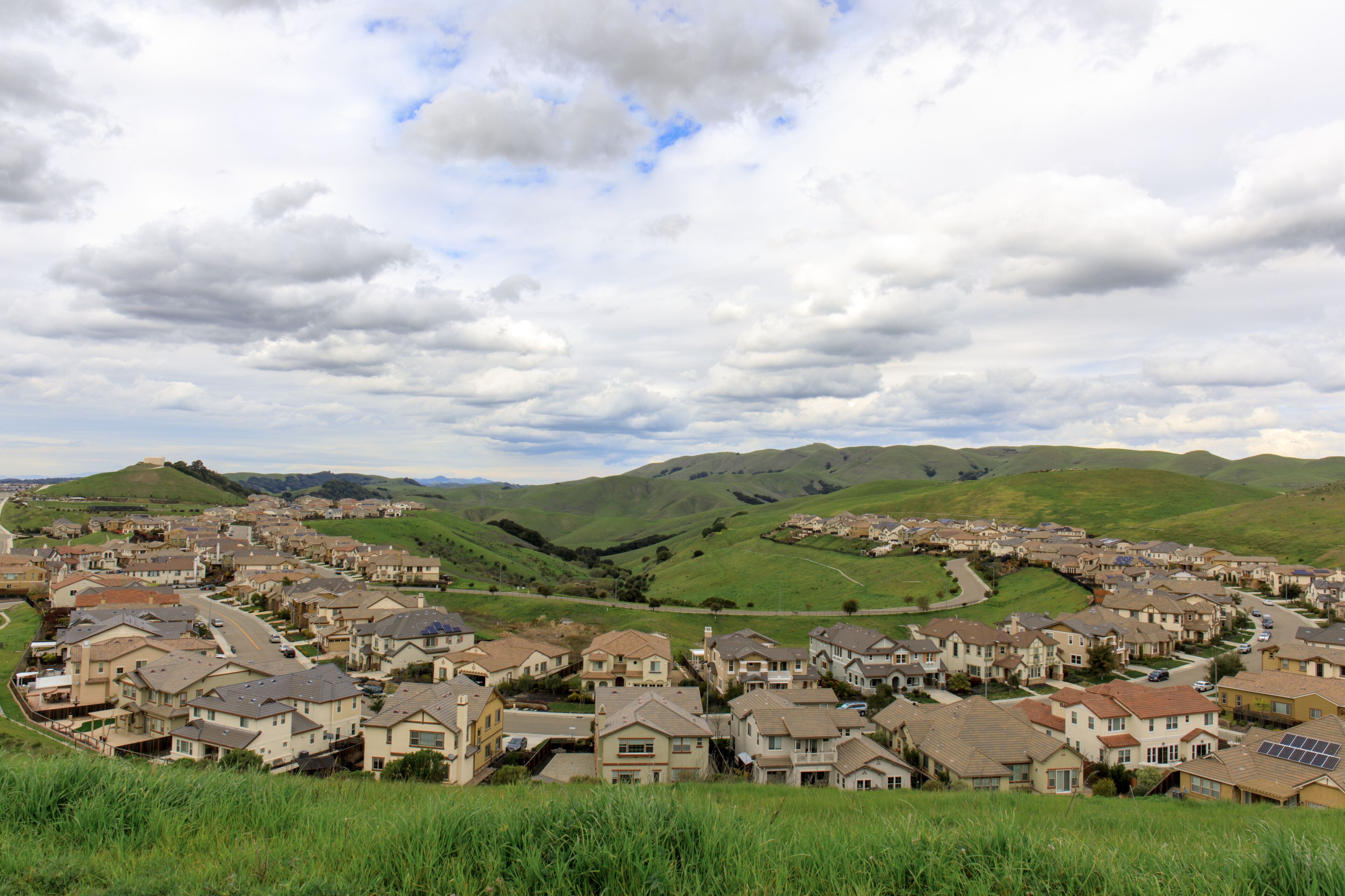 Residential Homes in Dublin Hills with approaching storm clouds in the winter. Dublin Hills Regional Park, Alameda County, California, USA.
