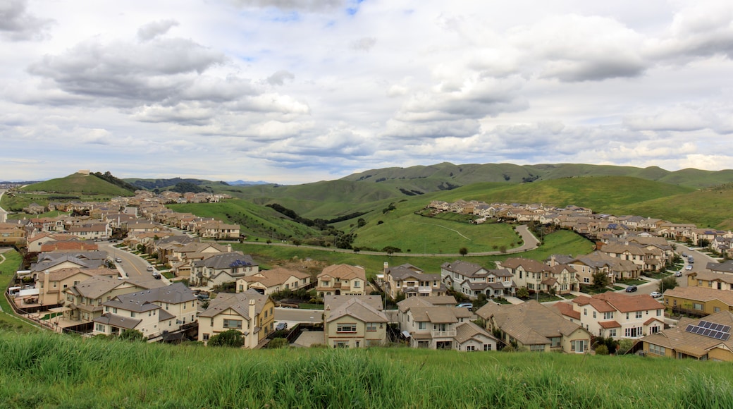 Residential Homes in Dublin Hills with approaching storm clouds in the winter. Dublin Hills Regional Park, Alameda County, California, USA.