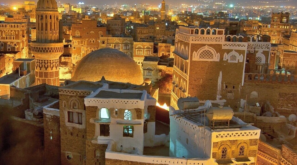 April 2008
Sana'a old city, Yemen
The sundawn view from rooftop of Taj Talha hotel in Sana'a old city to the west with Talha mosque minaret and dome. The city gets the illuminated from within its windows and streetlights and you hear the muezzin's calls for the prayer from all around you... It is a One thousand and one nights stories kind of experience...