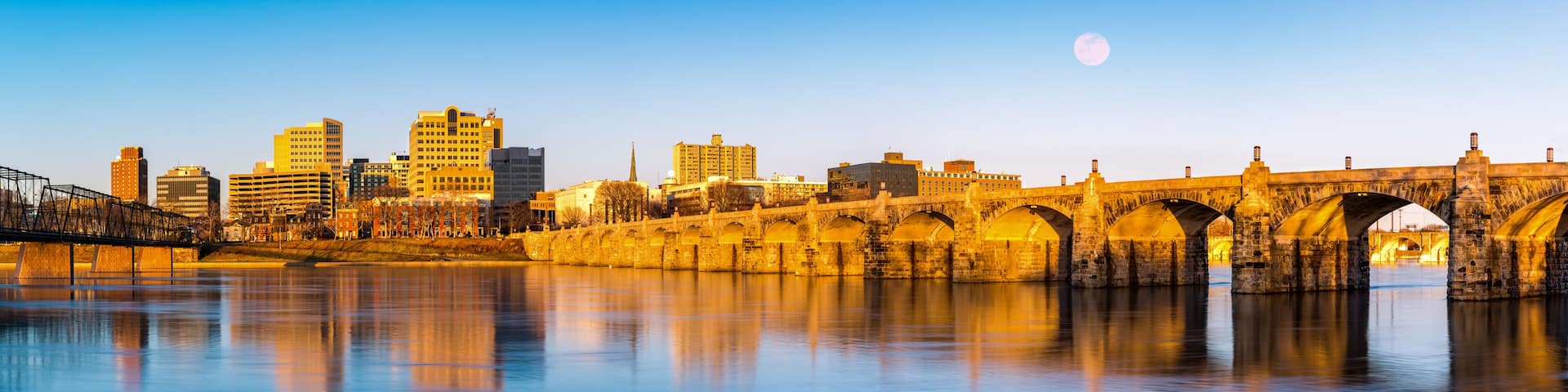 Harrisburg, Pennsylvania skyline with the historic Market Street Bridge reflected on the Susquehanna River at sunset