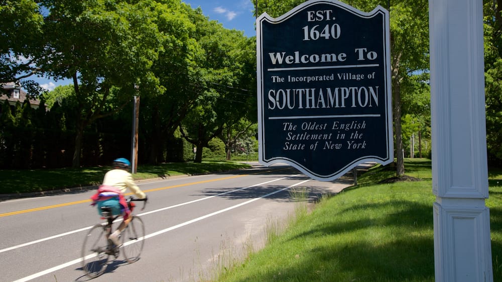 A welcome sign for the village of Southampton, established in 1640, with a cyclist on the road.