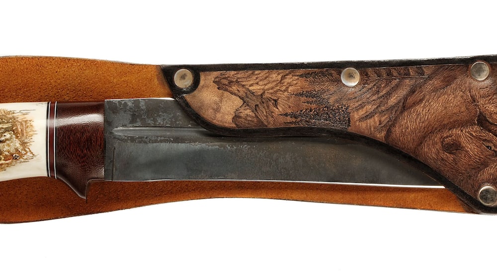 Hunting knife in scabbard with picture animals