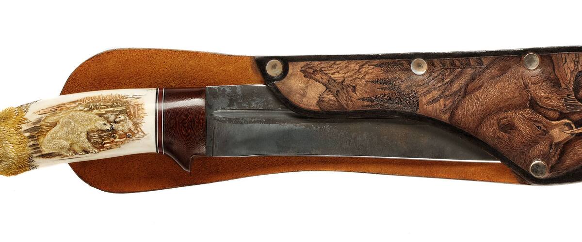 A knife with a wooden handle and a metal blade.