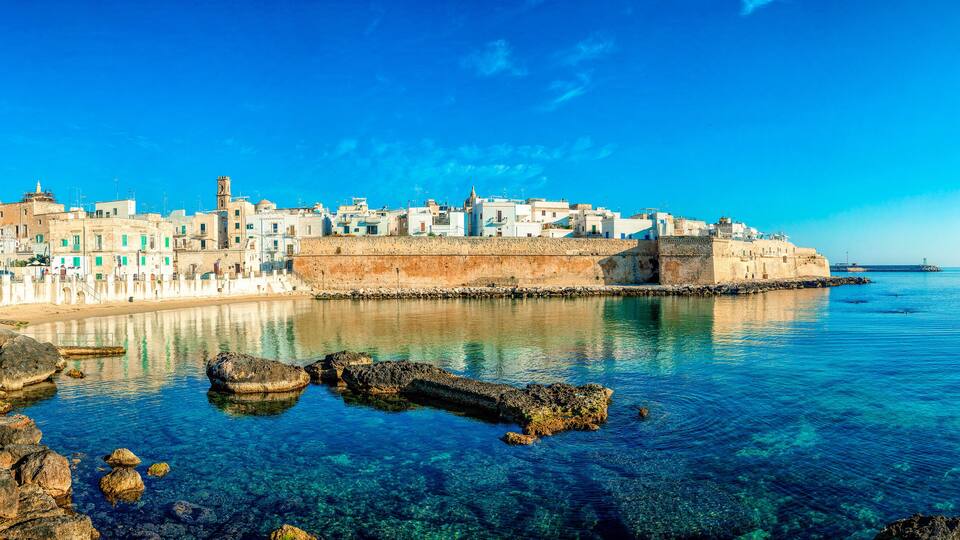 Panoramic view of Monopoli from the city beach of Cala Porta Vecchia, province of Bari, Puglia (Apulia), Italy, Europe. Monopoli seaside of Adriatic Sea, Puglia, Italy. Architecture of Monopoli