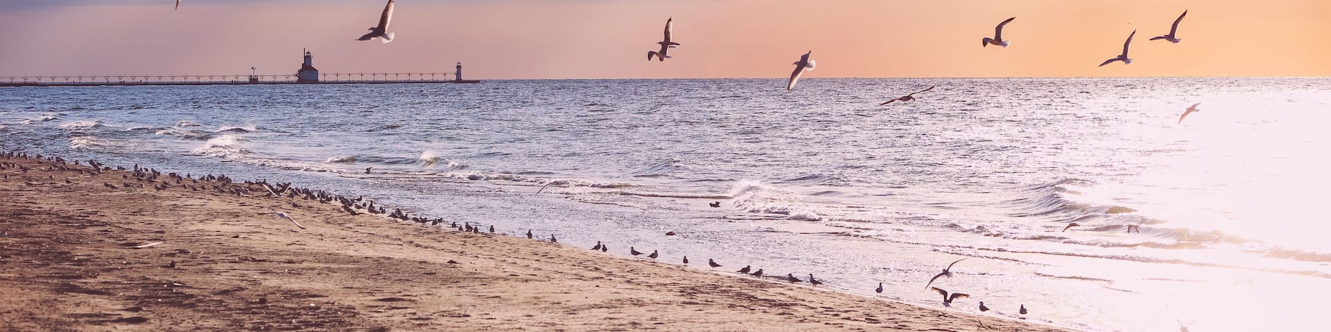 Beach background, rays of sunlight at sunset, Lake Michigan