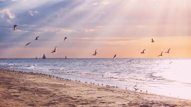 Beach background, rays of sunlight at sunset, Lake Michigan