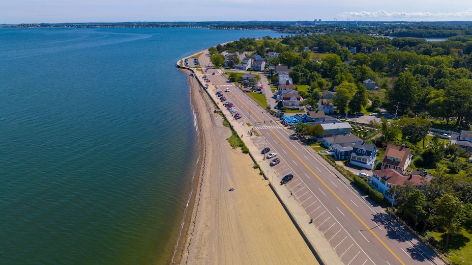 Wollaston Beach aerial view and Quincy Shore Drive next to the beach in Quincy Bay in Wollaston, city of Quincy, Massachusetts MA, USA.