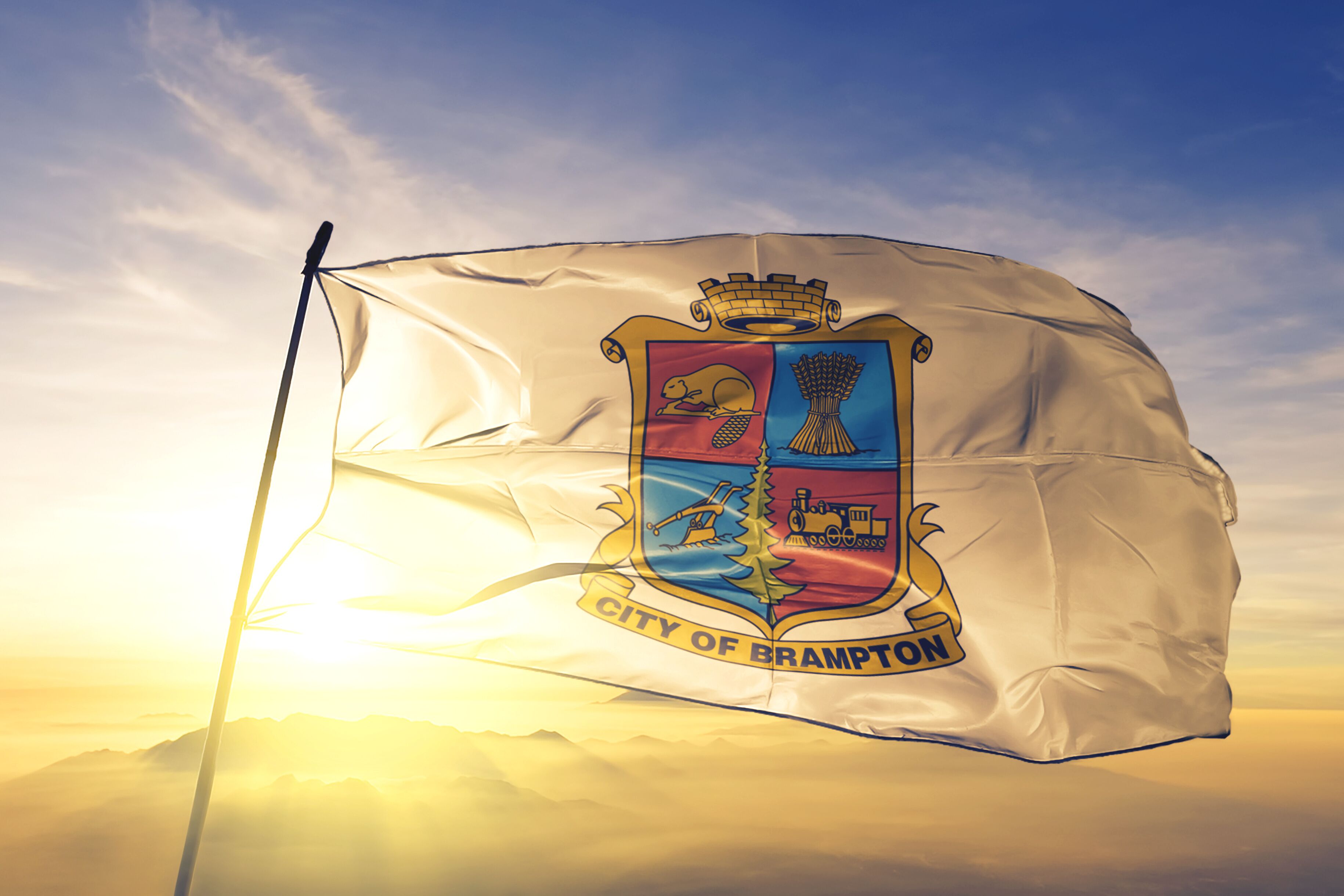 Brampton of Ontario of Canada flag waving on the top sunrise mist fog