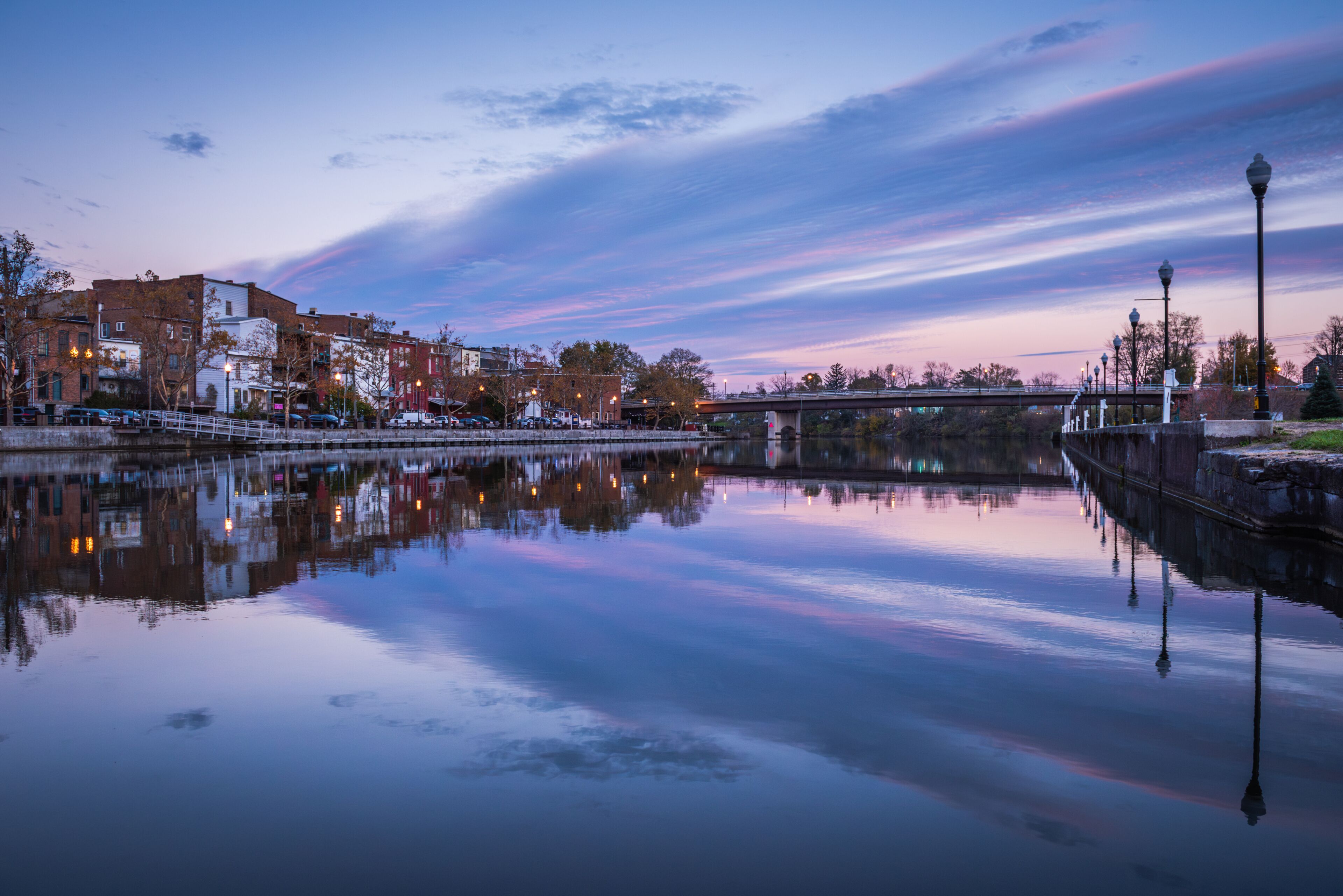 Cityscape of Seneca Falls, New York, along the Cayuga and Seneca Canal at dusk.