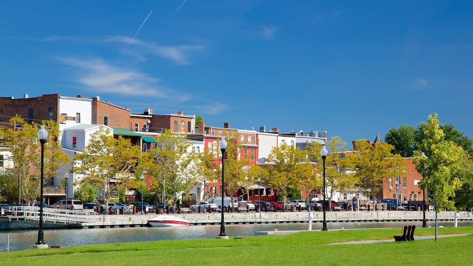 A riverside town with brick buildings, a bridge, and a boat dock.