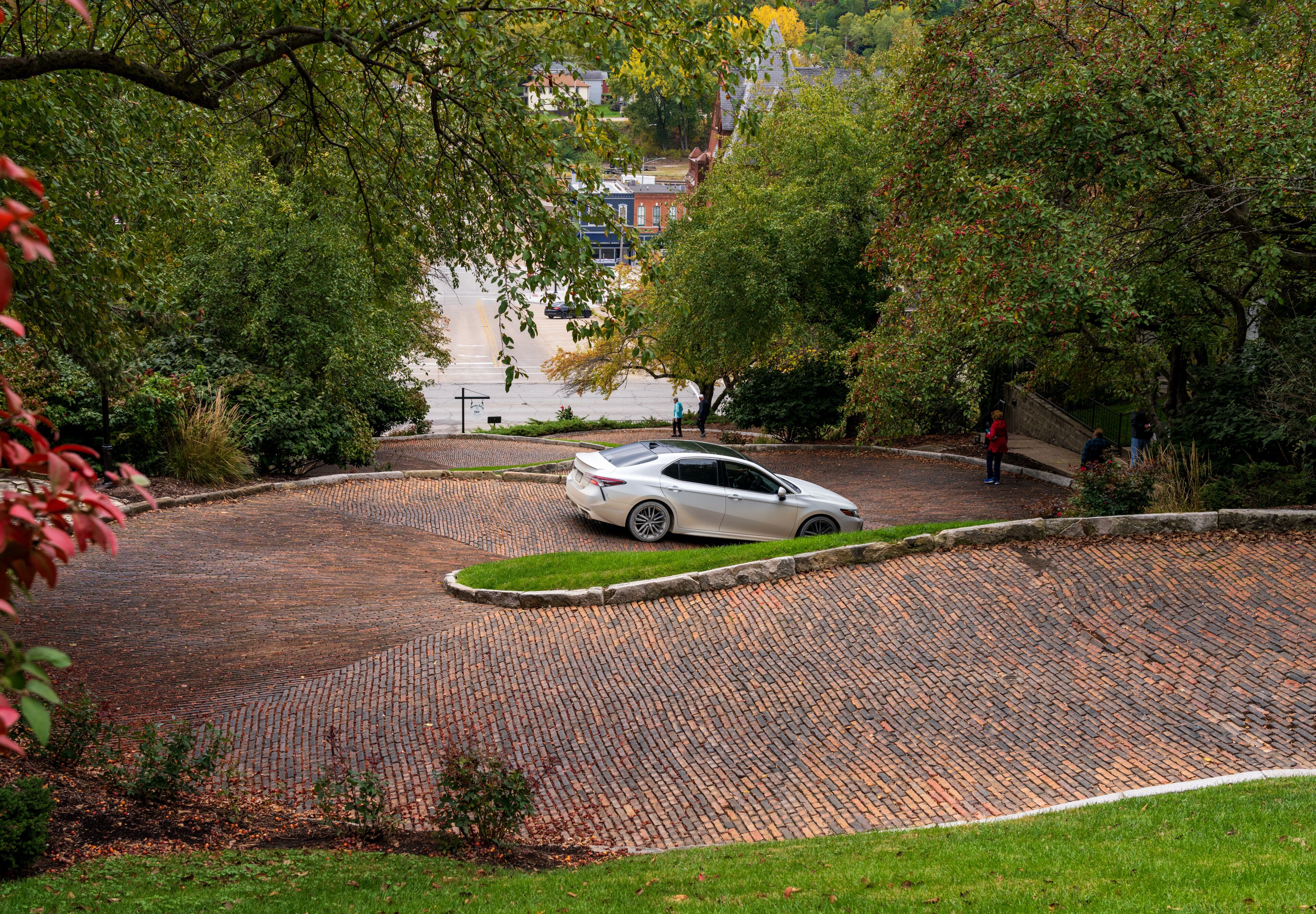 Car driving down Snake Alley in Burlington Iowa which has the world record for steepest bendy street