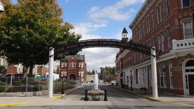 The oldest concrete street in America can be found in Bellfontaine, Ohio. In 1891, Bellefontaine became the location of the first concrete street in America. George Bartholomew invented a process for paving using Portland cement, which until then had been used in stone construction. A small section of Main Street, on the west side of the Logan County Courthouse, was the first to be paved using that process. When that proved successful, Court Avenue, which runs along the south side of the courthouse, was then paved. While Main Street is now paved with asphalt, Court Avenue has retained its original concrete pavement for over 100 years. At its centennial, the street was closed and a statue of Bartholomew placed at its Main Street end, although since then one lane has been reopened for eastbound traffic.