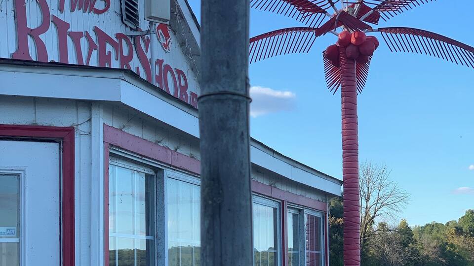 A building with a sign reading "Tim's Riveror."