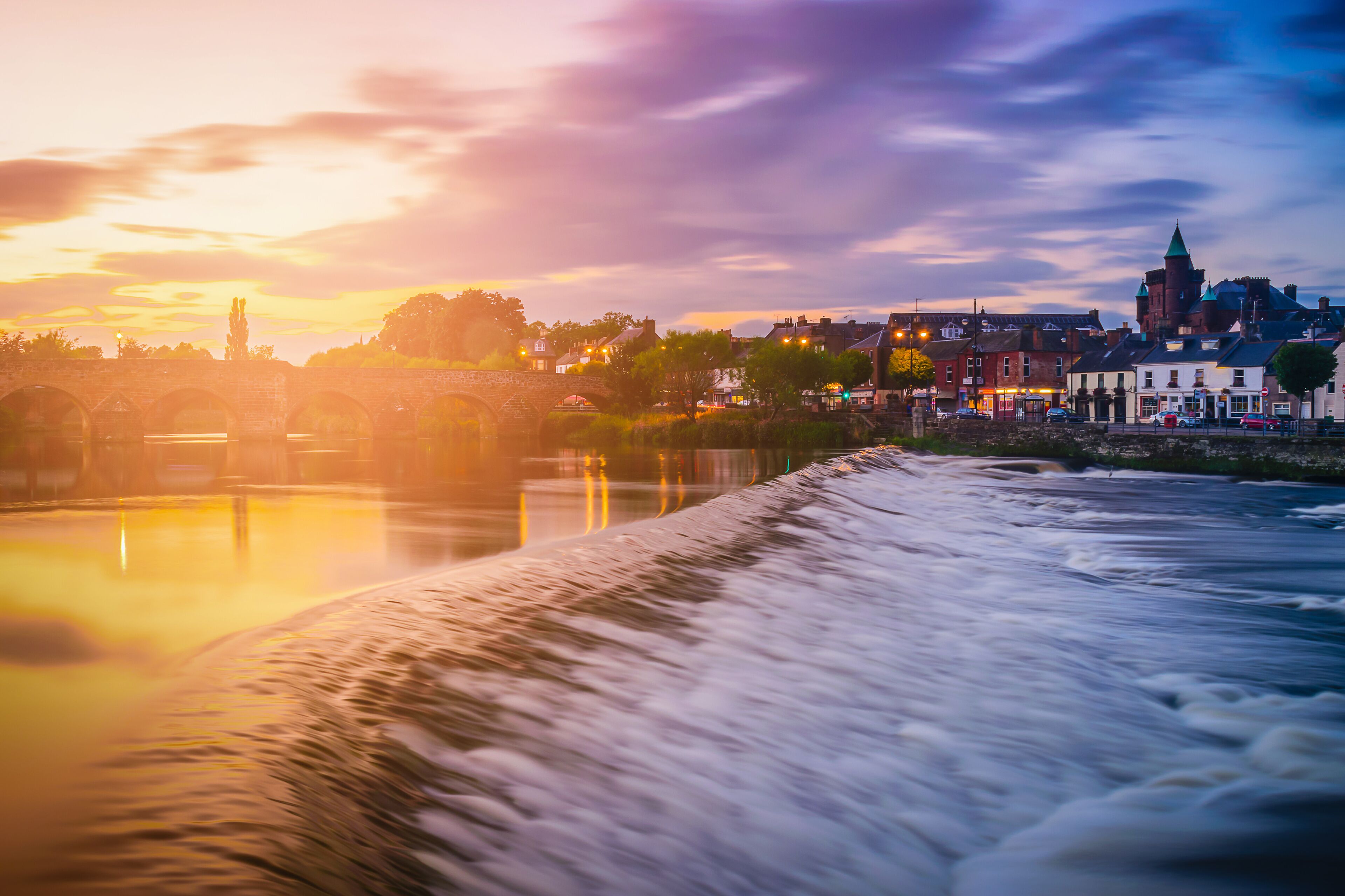 The River Nith and old bridge at sunset in Dumfries, Scotland, UK.