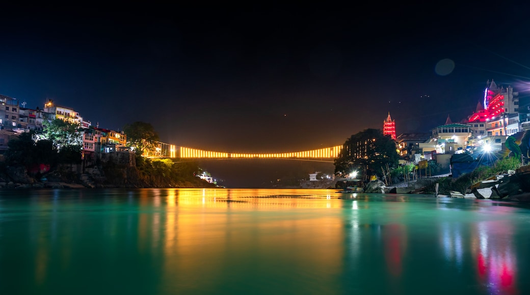 Spectacular illuminated panoramic cityscape of Rishikesh, the yoga capital of World located in foothills Himalayas along banks of river Ganga or Ganges in Uttarakhand state of India.