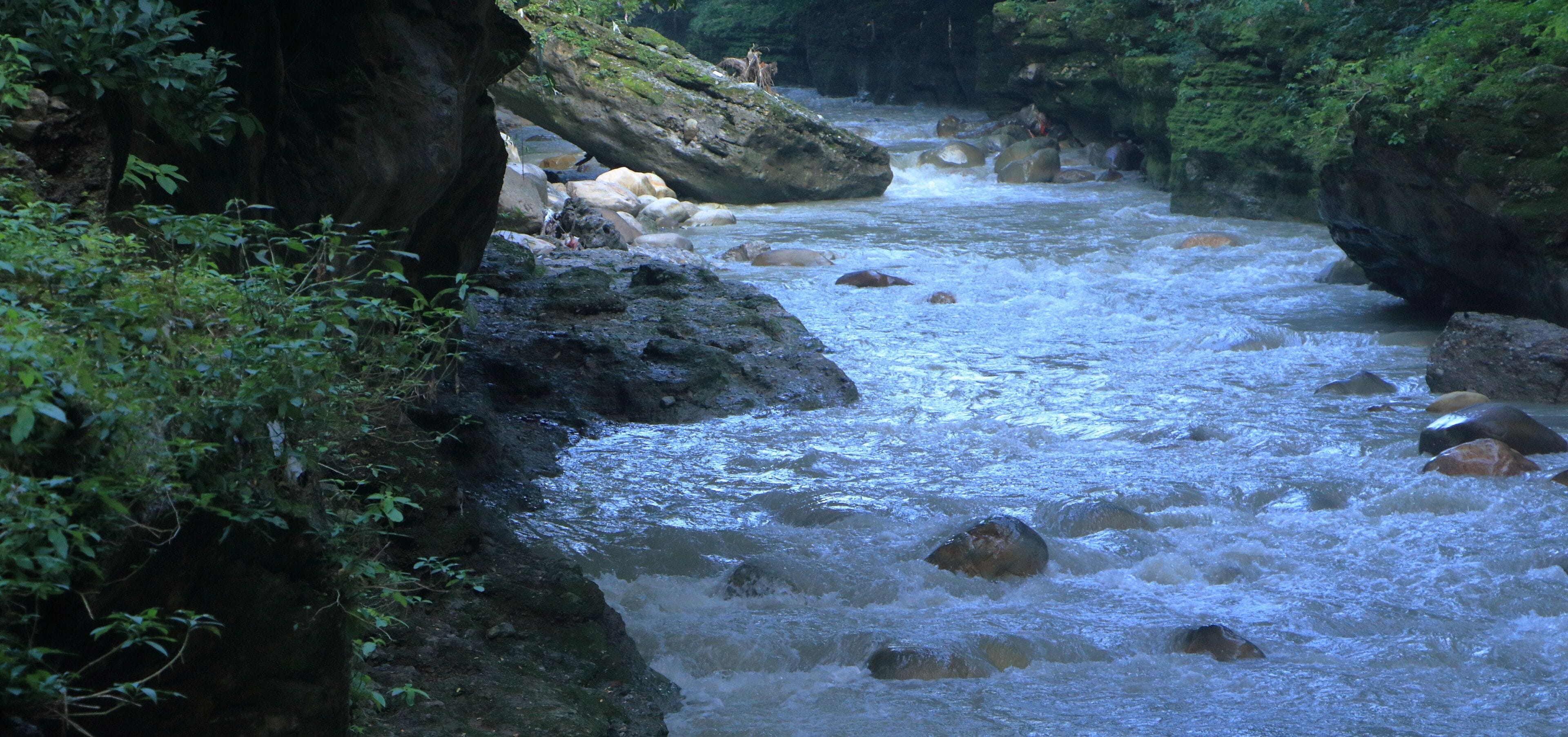Beautiful views of the flowing river at Tapkeshwar Temple in Dehradun from different angles.