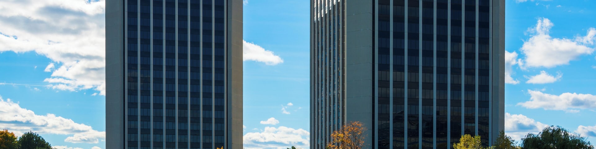 Park Lane Towers, a twin tower office complex in Dearborn, Michigan, with a pond with water fountains in the foreground. Dearborn is a part of the Metro Detroit area.