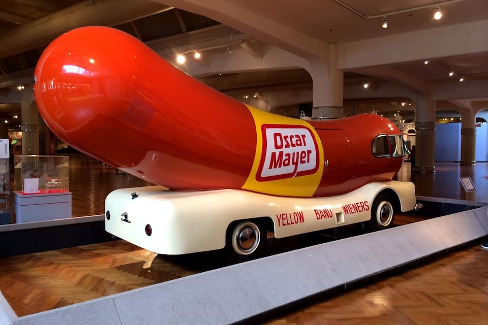 A hot dog-shaped vehicle with 'Oscar Mayer' branding displayed prominently.