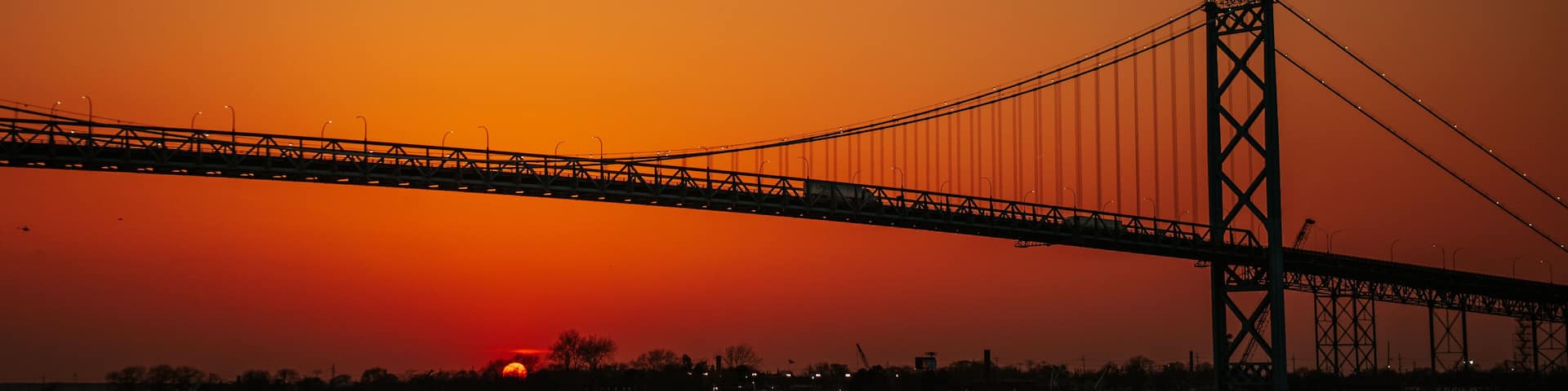 A bridge silhouetted against a sunset sky.
