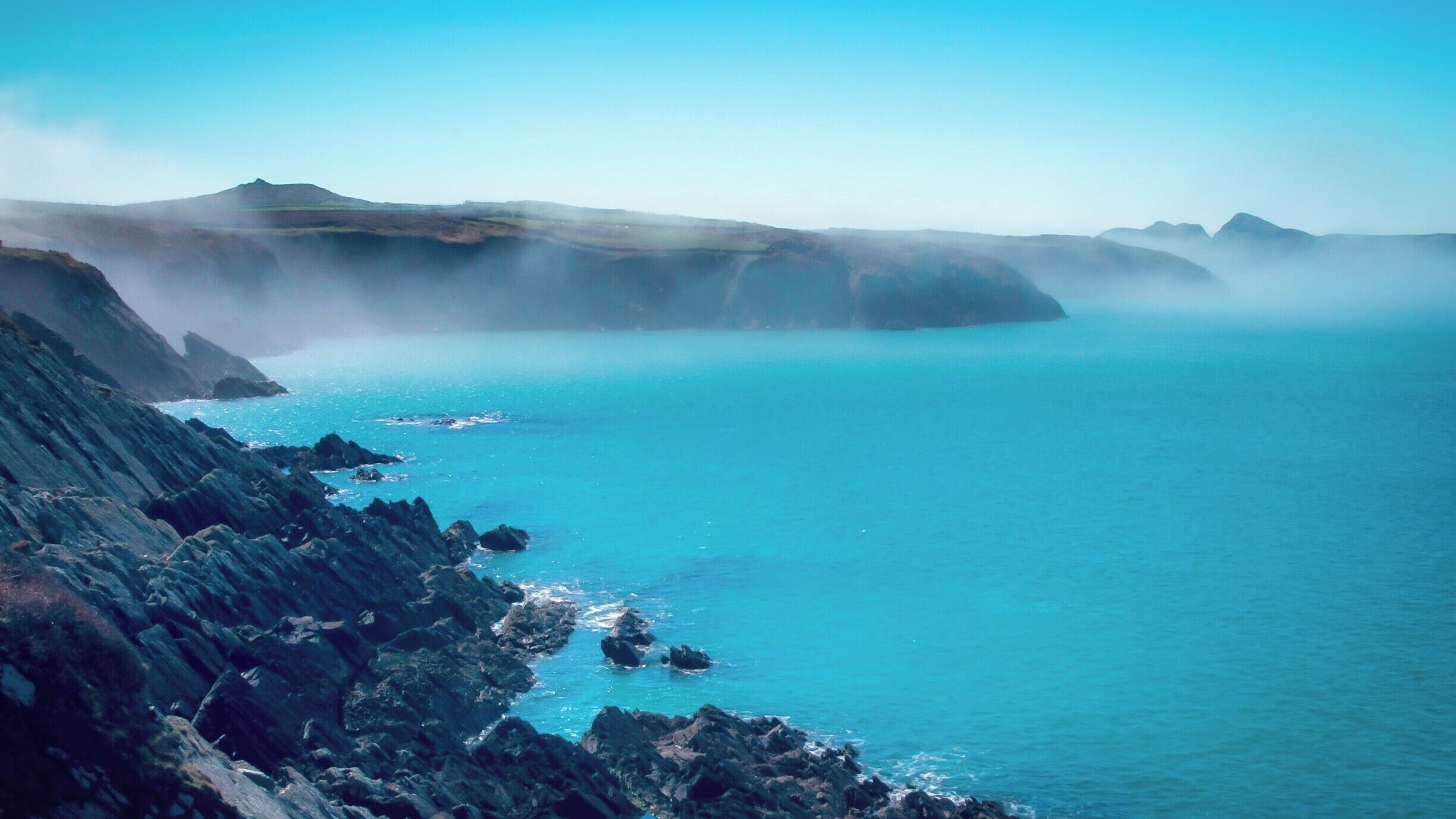 The morning mist coming in from the sea makes for a rather mysterious photo of the rugged Welsh coastline. 