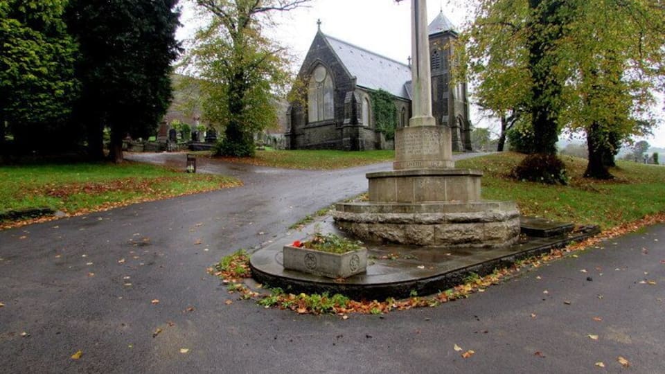 War Memorial Cross in Trealaw Cemetery Located near the main cemetery entrance from Brithweunydd Road. The Grade II listed cemetery chapel is in the background.