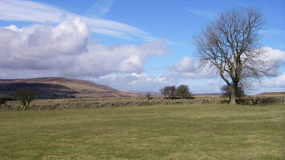 Above Pen-y-ddoyga Enclosed land reaches high onto the moorland of Mynydd Garn-wen in the slight shelter of Cwm Lasgarn. Mynydd Varteg features prominently in the distant view.