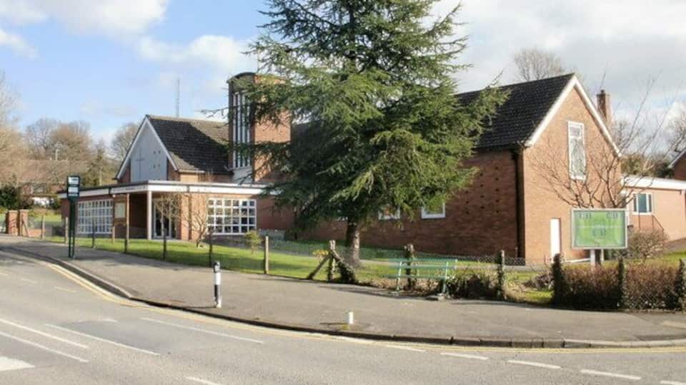 Llanyrafon Methodist Church, Cwmbran. Viewed from Llanyrafon Way. Comparison with a photo taken one year earlier 1200800 shows that one of the trees has been chopped down, with only a small stump remaining, allowing a little more of the church to be seen now.