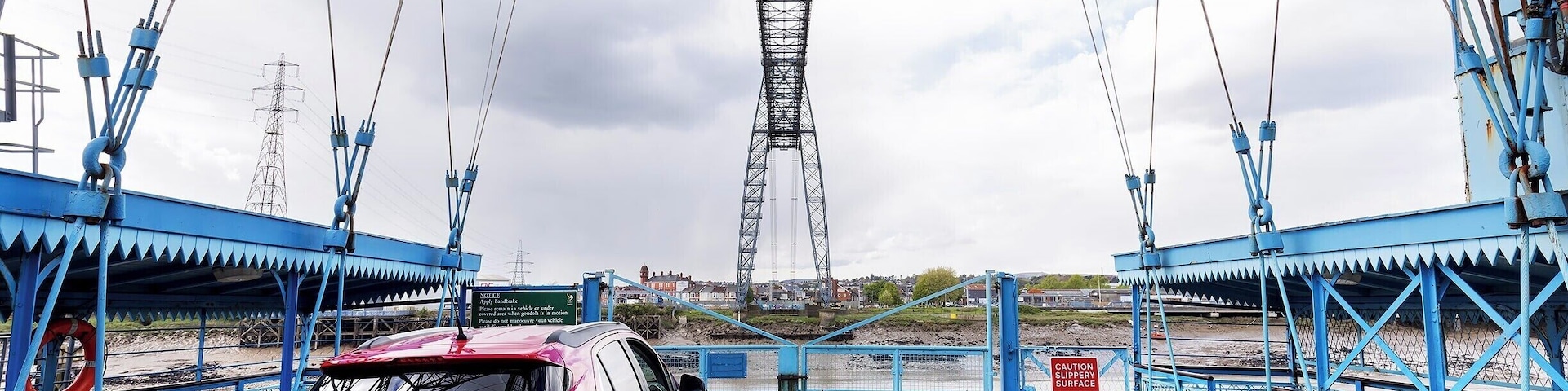 The coolest "bridge" I have ever "driven" across! Drive aboard and take flight over the River Usk in this 110 year old engineering marvel. Only six of these historic bridges remain in operation, and the Newport Bridge is the longest with a 196m span (645ft).
A modern highway bridge passes nearby, so these days the bridge operates as a novelty. Show up on either side, and the operator will come pick you up! You can also climb the steps and walk across the 54m (180ft) high catwalk.