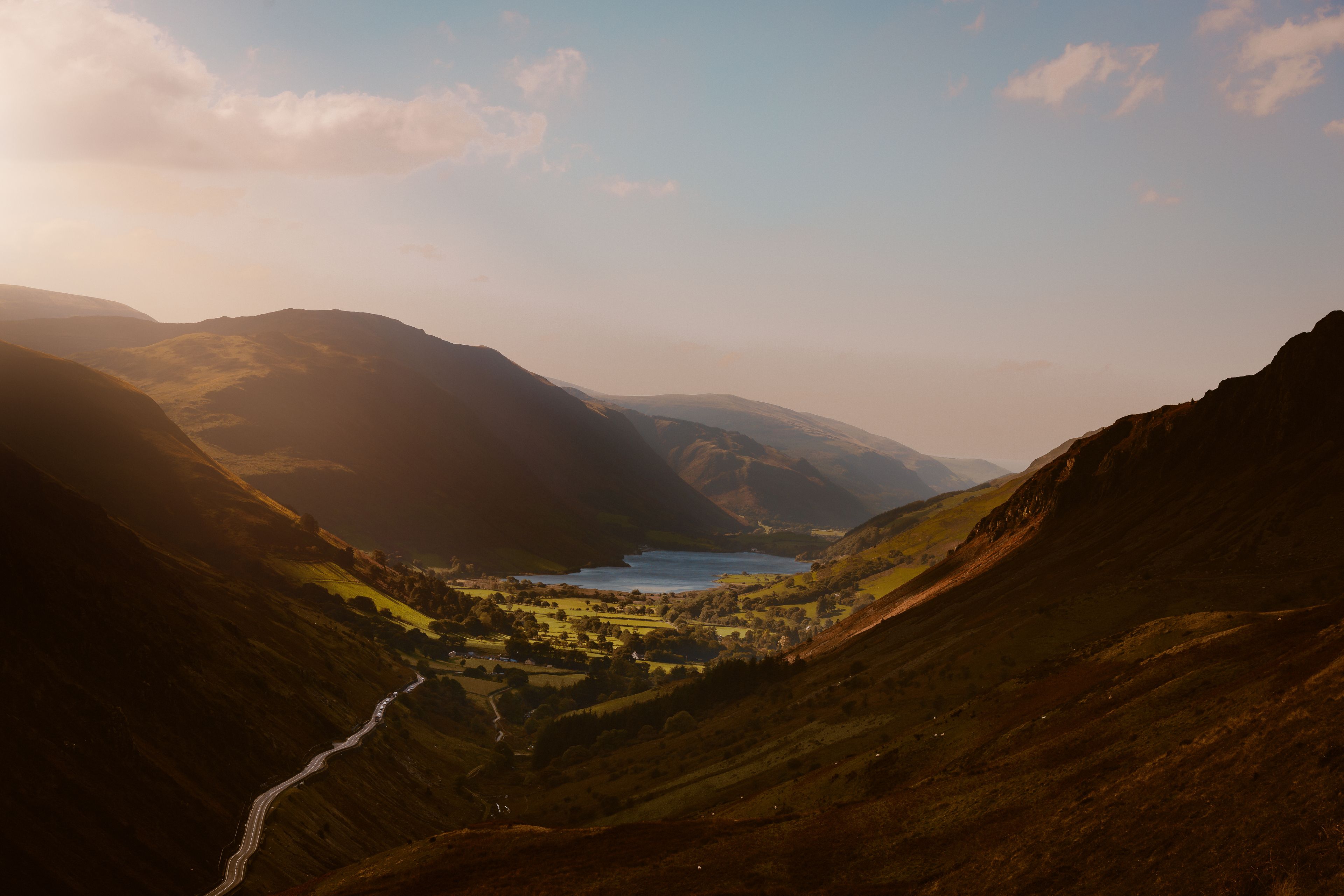 A valley with a lake, surrounded by mountains.