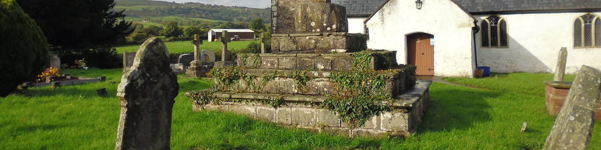 Remains of medieval preaching cross in the graveyard of St Peter's Church. Henllys, Cwmbran. This is a scheduled ancient monument in Torfaen.