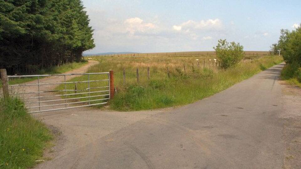 Gated lane junction north of Mynydd Ty-talwyn View, looking roughly eastwards, of a junction in the north of the grid square where a rather bumpy lane which has run south west from the A 4063 in the Llynfi Valley meets the mountain lane which passes through the square - as well as a gate.