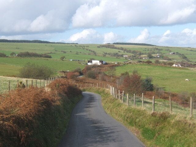 Lane above Gilfach With scattered farm buildings on the high valley slopes.