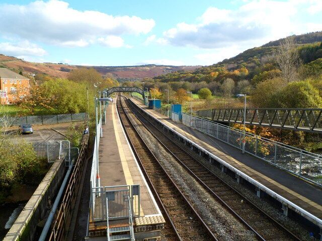 Ystrad Rhondda railway station. The station is on the Rhondda Line, between Llwynypia station (about a mile ahead) and Ton Pentre station, a little less than a mile behind the camera. The twin tracks through the station merge into one track beyond the footbridge ahead. Of interest to trivia fans - Ystrad Rhondda is alphabetically the last railway station in the UK.