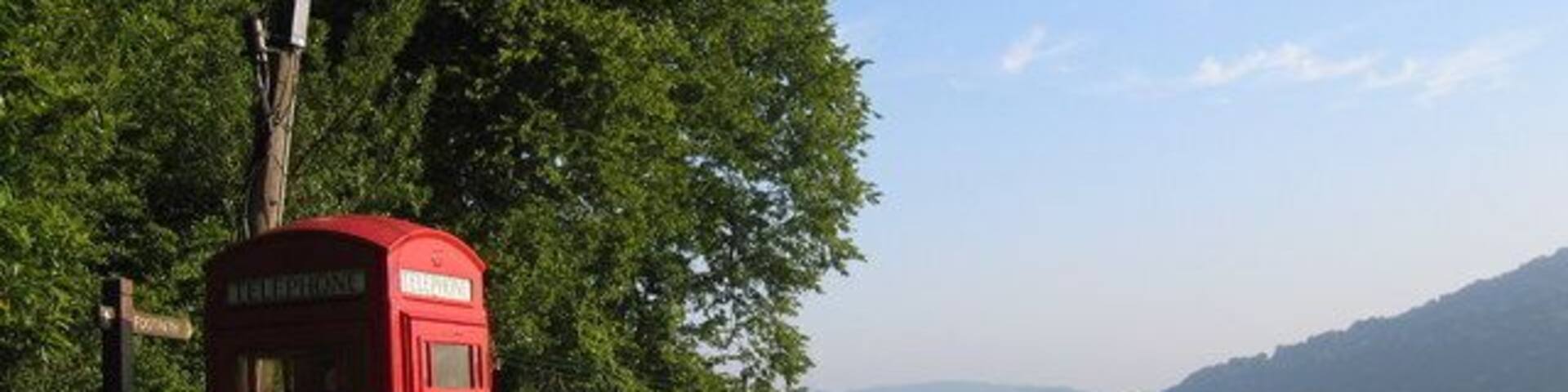 Rural phone box, leaning phone pole A phone box with a view, looking north towards Monmouth, with the River Wye in the valley below