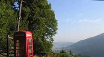 Rural phone box, leaning phone pole A phone box with a view, looking north towards Monmouth, with the River Wye in the valley below