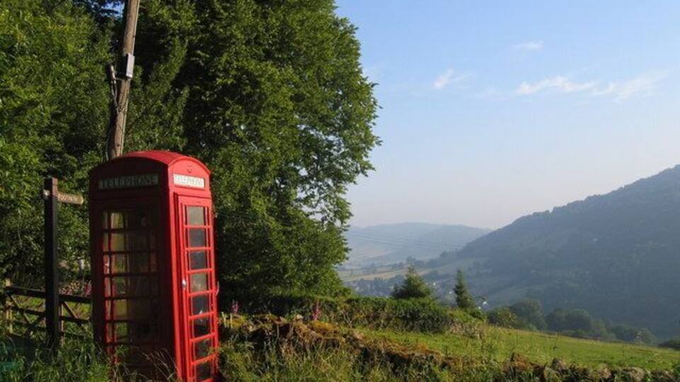 Rural phone box, leaning phone pole A phone box with a view, looking north towards Monmouth, with the River Wye in the valley below