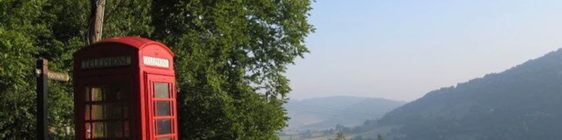 Rural phone box, leaning phone pole A phone box with a view, looking north towards Monmouth, with the River Wye in the valley below