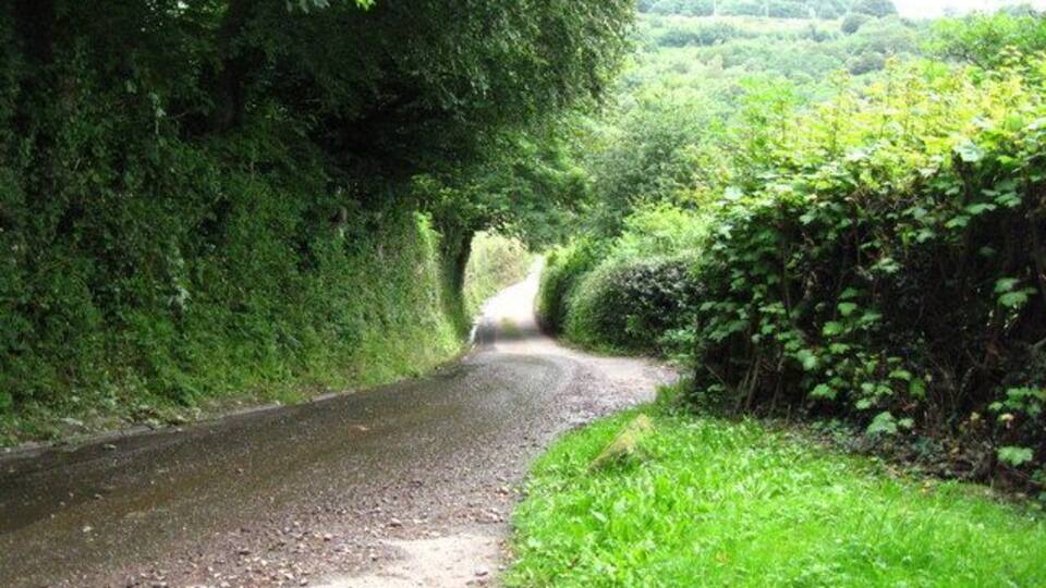 Ty-bwmpyn Lane This picture was taken from the entrance to the drive to Yew Tree Cottage. It shows how narrow the lane is. The recent heavy rainfall has caused gravel to be washed onto the road.