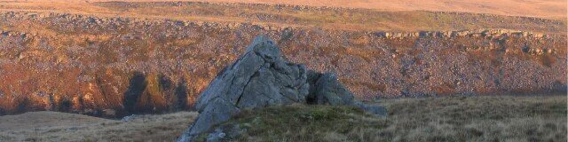South portion of Tyle Garw. Tyle Garw is the rocky east ridge of the gorge that the Twrch runs through. This is a view of the southern portion of it, southeast across the valley from below Carn Fadog.