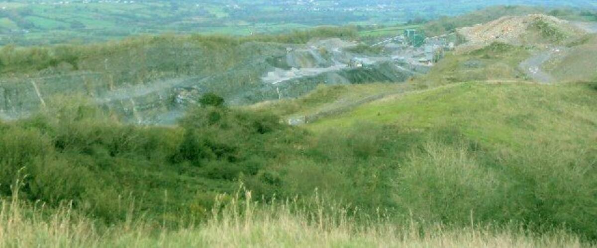 A hilly landscape with a road winding through it.